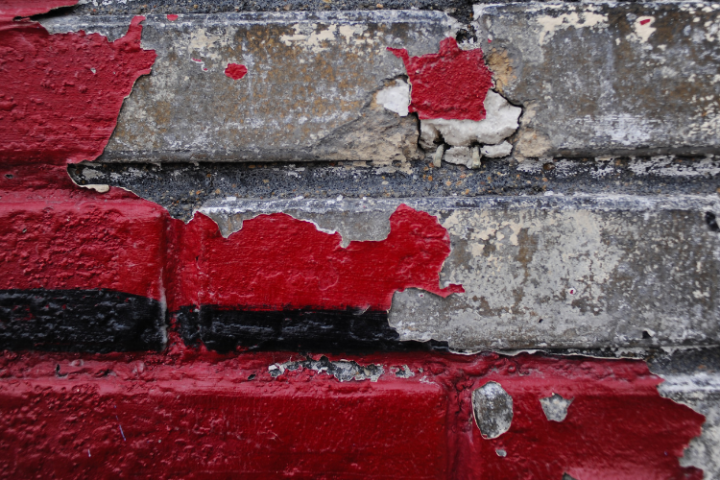 Brick with cracked exterior paint.
