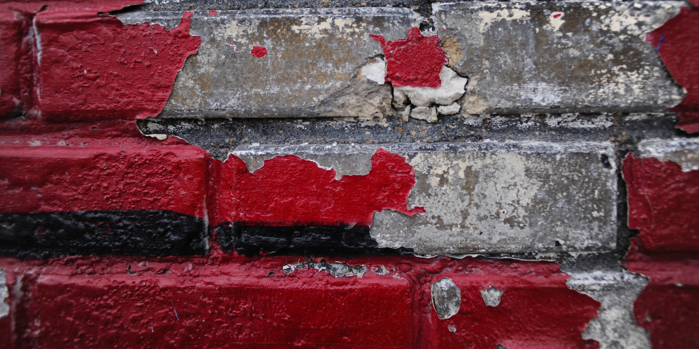 Brick with cracked exterior paint.