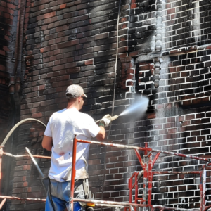 Environmentally Friendly Paint Removal Methods For Brick Houses Paint Removal Professional_man_pressure_washing_brick